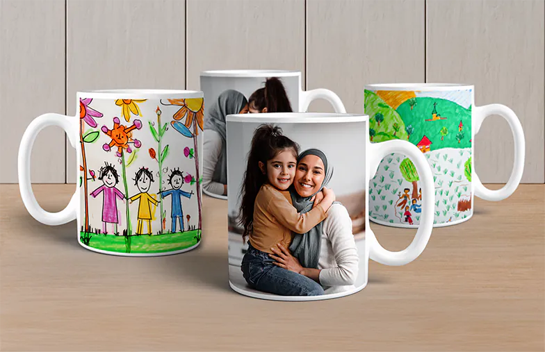 Personalised Photo Mugs from Printerpix|Mother and baby holding a custom mug with a cartoon design from Printerpix and the text "Dad"|Personalised photo mug with a picture of a crawling baby in an animal onesie|Mother and daughter holding custom-made photo mugs with family photos|Kissing couple with personalised mugs with text|Personalised photo mug with your own photo of a dog on it|||||