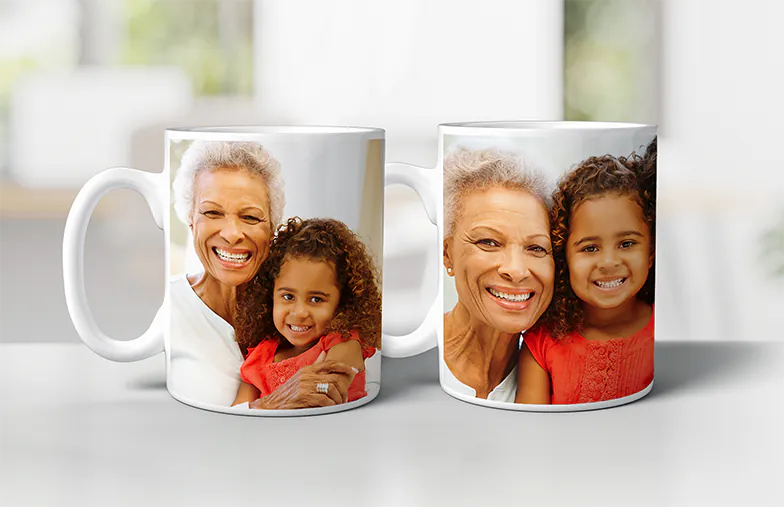 ["Personalised Photo Mugs by Printerpix", "Mother and baby holding a custom mug from Printerpix with cartoon design and 'Papa' text", "Personalised photo mug featuring a crawling baby in an animal onesie", "Mother and daughter holding custom photo mugs with family pictures", "Kissing couple with personalised mugs with text", "Personalised photo mug with your own photo of a dog on it", "", "", "", ""]||||||||||