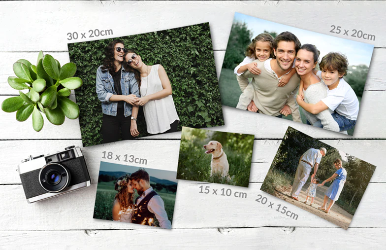 Small, medium, and large photo prints on a table from a mobile phone