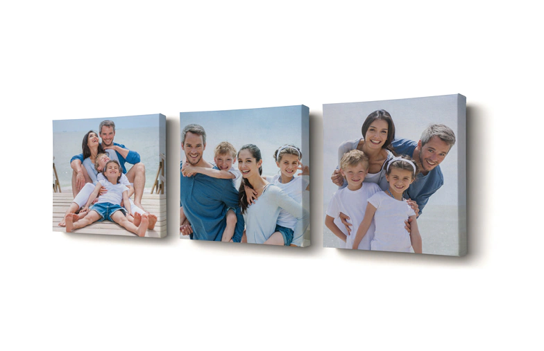 Mother and four small children sitting on the sofa in front of four photo canvases